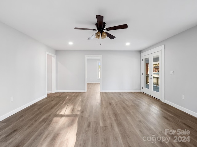 unfurnished room with french doors, ceiling fan, and hardwood / wood-style flooring