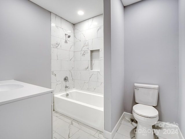 full bathroom featuring toilet, tiled shower / bath, and vanity