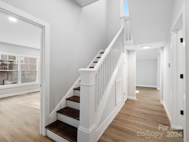 stairs featuring hardwood / wood-style floors