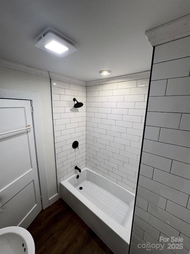 bathroom with bathing tub / shower combination and wood finished floors