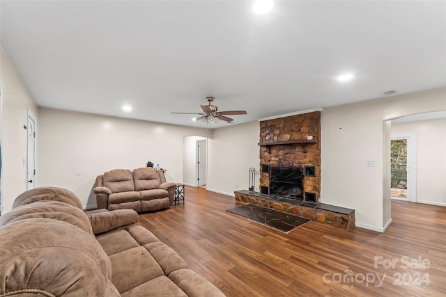 living room with hardwood / wood-style floors, a fireplace, and ceiling fan