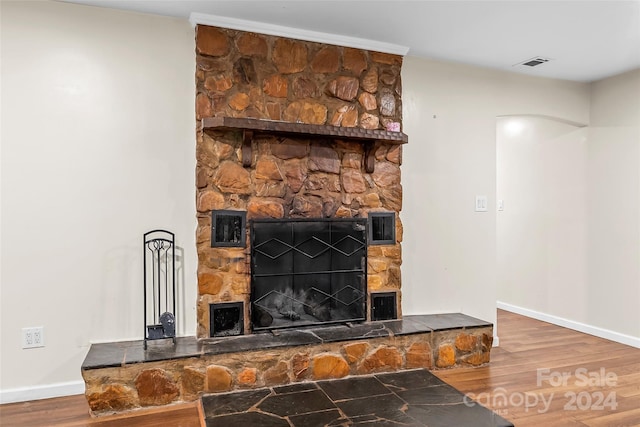 interior details featuring a fireplace and wood-type flooring