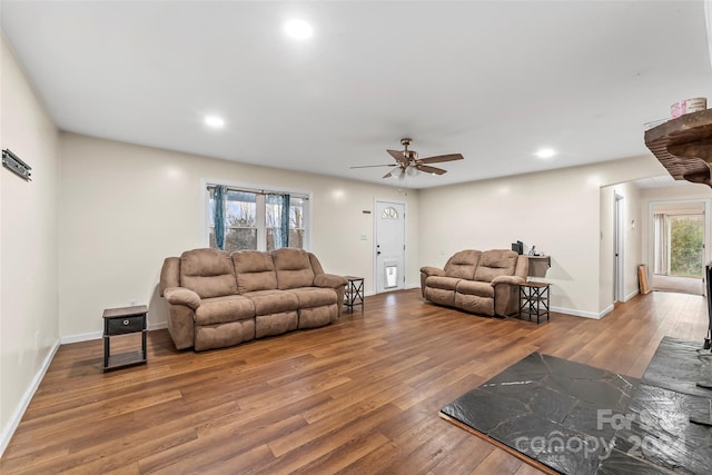 living room featuring hardwood / wood-style floors and ceiling fan