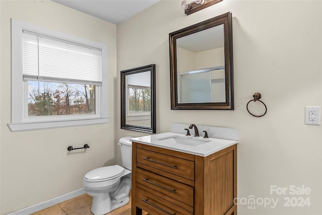 bathroom featuring toilet, an enclosed shower, vanity, and tile patterned floors