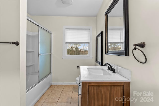 full bathroom with vanity, bath / shower combo with glass door, tile patterned flooring, and a healthy amount of sunlight