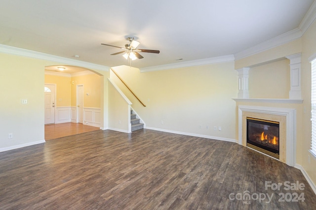 unfurnished living room with dark hardwood / wood-style flooring, ceiling fan, and crown molding