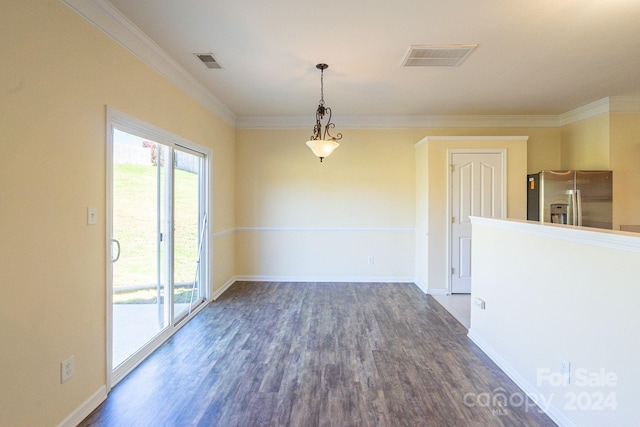 spare room featuring dark wood-type flooring and crown molding