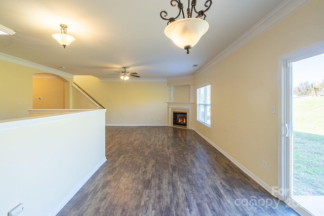 unfurnished living room featuring dark hardwood / wood-style flooring, ceiling fan, and crown molding