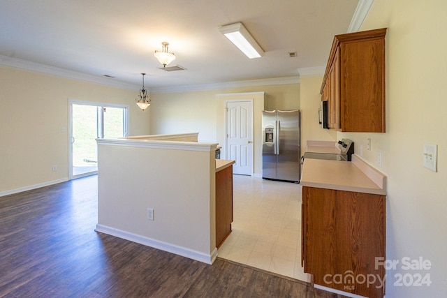 kitchen with stainless steel appliances, light hardwood / wood-style flooring, decorative light fixtures, and ornamental molding