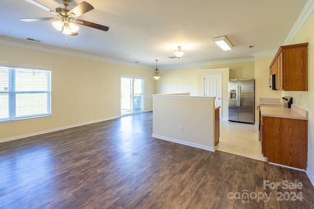 kitchen with stainless steel appliances, dark wood-type flooring, crown molding, and plenty of natural light