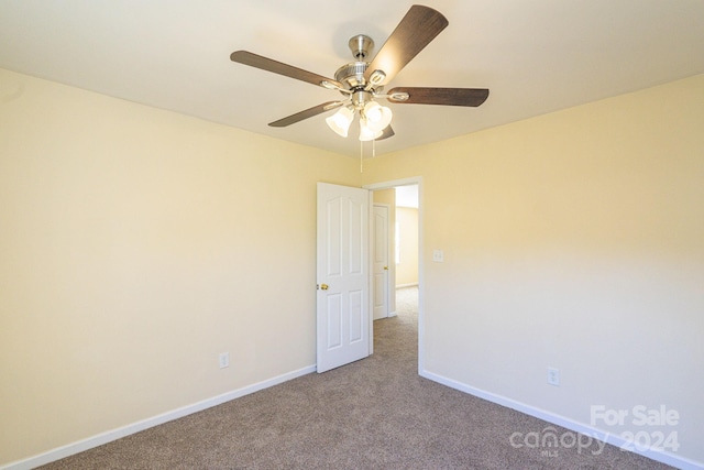 empty room featuring carpet and ceiling fan