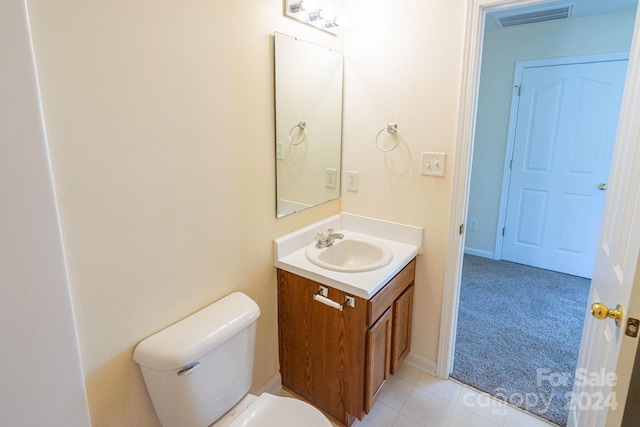 bathroom featuring tile patterned flooring, vanity, and toilet