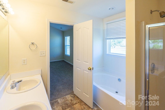 bathroom with vanity and independent shower and bath