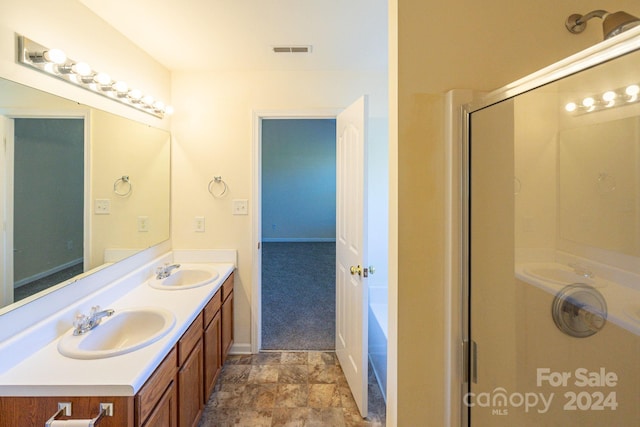 bathroom featuring walk in shower and vanity