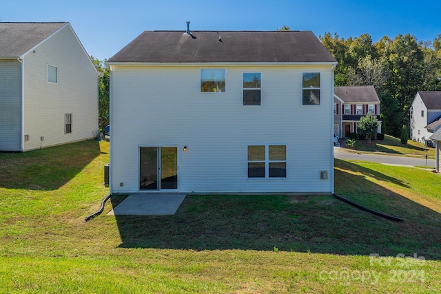 back of house with a lawn