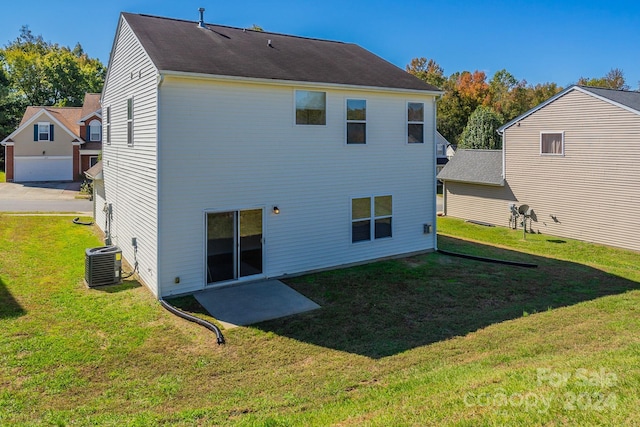 rear view of property featuring central AC and a yard