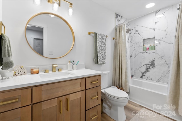 full bathroom with toilet, hardwood / wood-style floors, shower / tub combo with curtain, and vanity