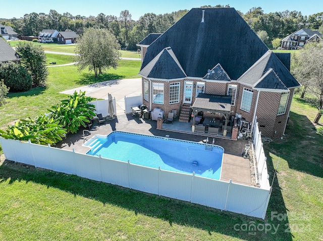 view of swimming pool featuring a patio and a lawn