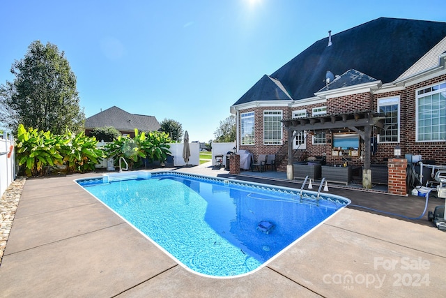 view of swimming pool with a patio and a pergola