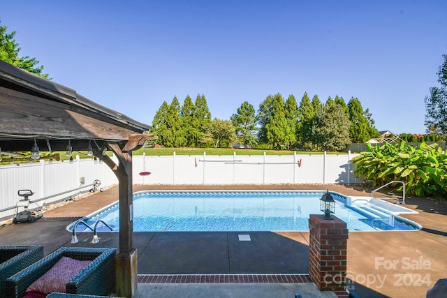 view of swimming pool featuring a patio area