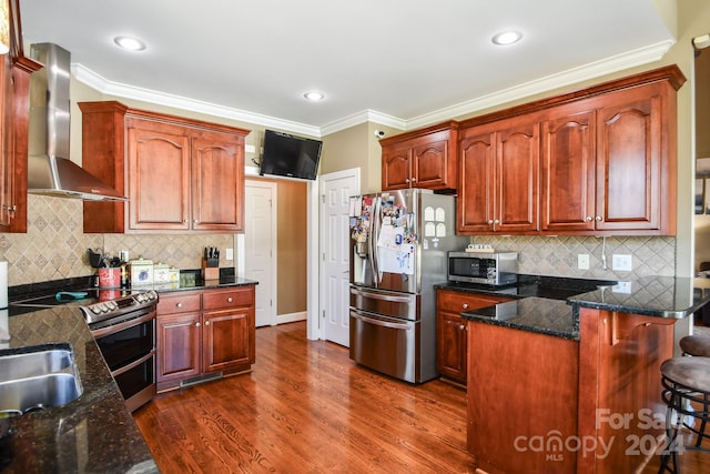 kitchen featuring stainless steel appliances, wall chimney exhaust hood, crown molding, decorative backsplash, and dark hardwood / wood-style floors