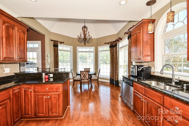 kitchen with dishwasher, decorative backsplash, hardwood / wood-style flooring, sink, and decorative light fixtures