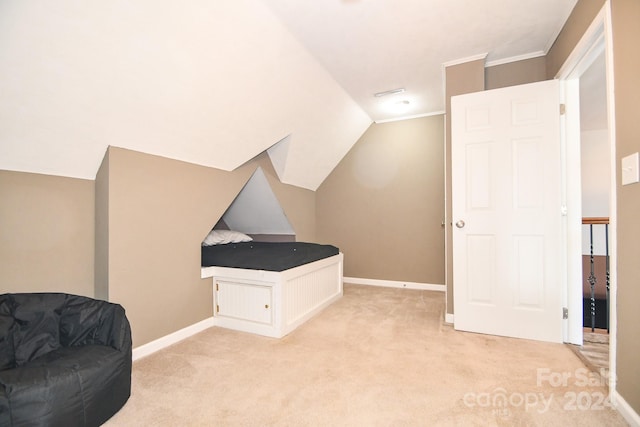 sitting room featuring vaulted ceiling and light colored carpet