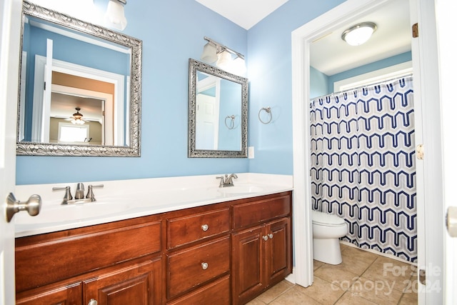 bathroom with ceiling fan, toilet, vanity, curtained shower, and tile patterned flooring