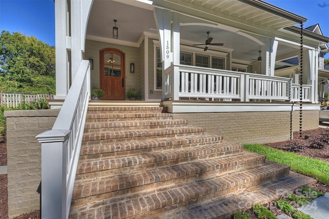 entrance to property featuring ceiling fan and covered porch