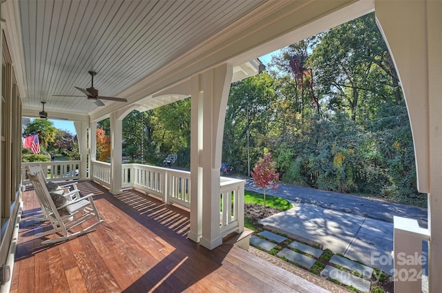 deck featuring covered porch and ceiling fan