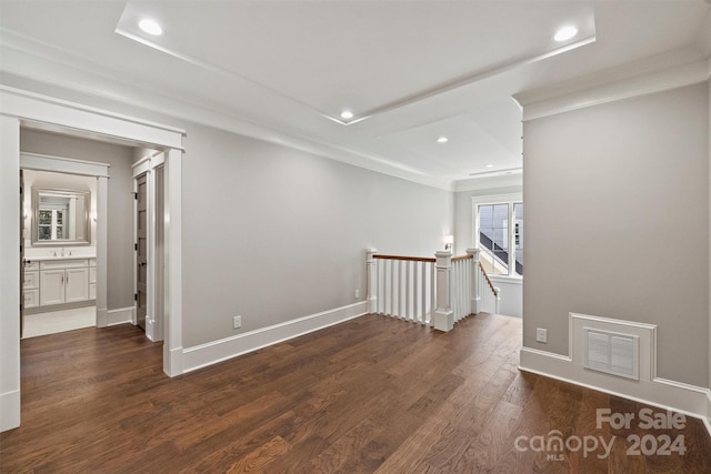 unfurnished room with dark wood-type flooring and ornamental molding