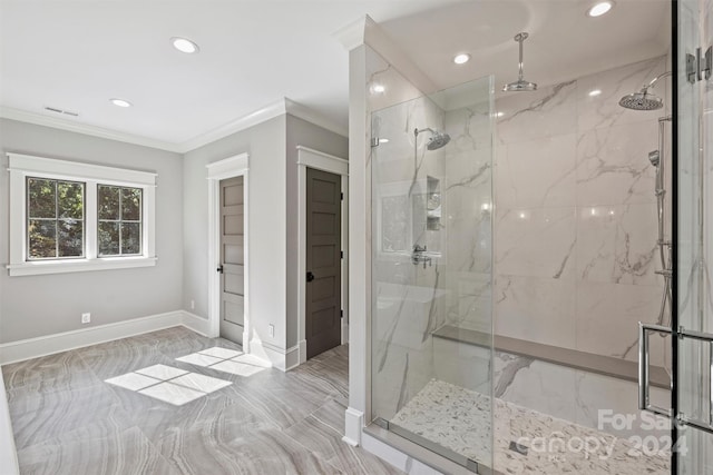 bathroom featuring a tile shower and crown molding