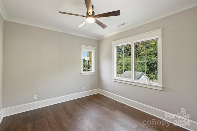 empty room featuring dark hardwood / wood-style floors, ceiling fan, and crown molding