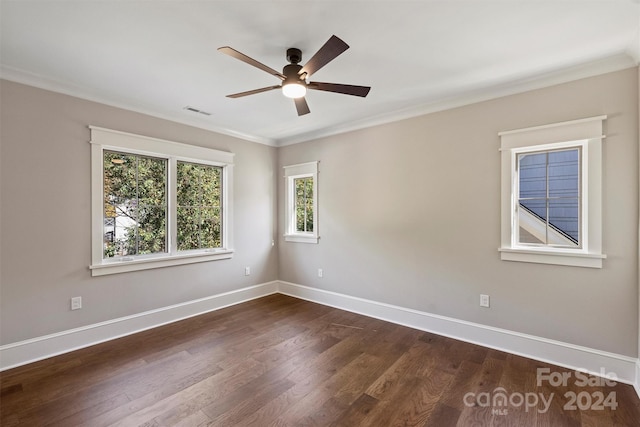 empty room with dark hardwood / wood-style floors, ceiling fan, and ornamental molding