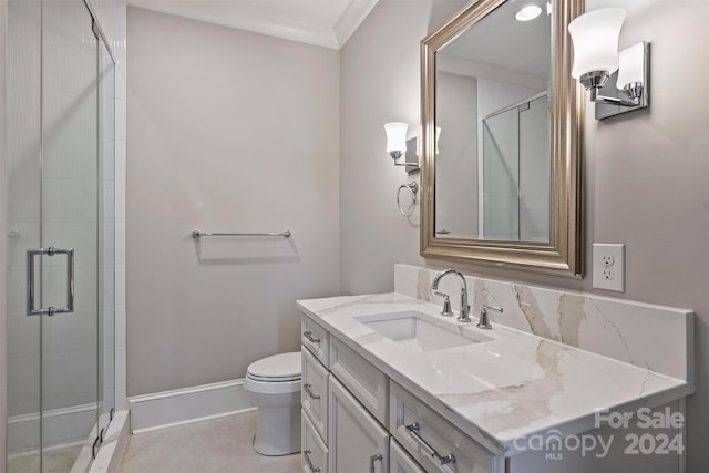 bathroom with vanity, toilet, an enclosed shower, and ornamental molding