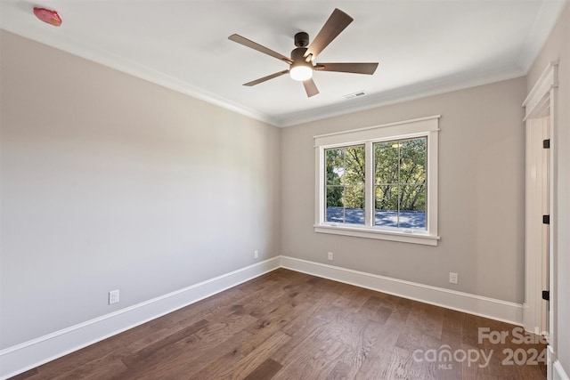 empty room featuring dark hardwood / wood-style floors, ceiling fan, and ornamental molding