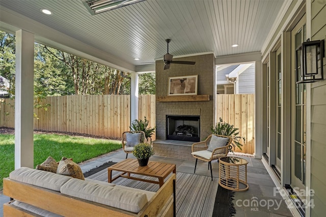 view of patio featuring an outdoor living space with a fireplace and ceiling fan