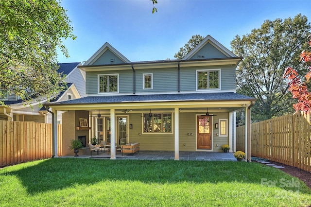 back of property featuring outdoor lounge area, a yard, a patio, and ceiling fan