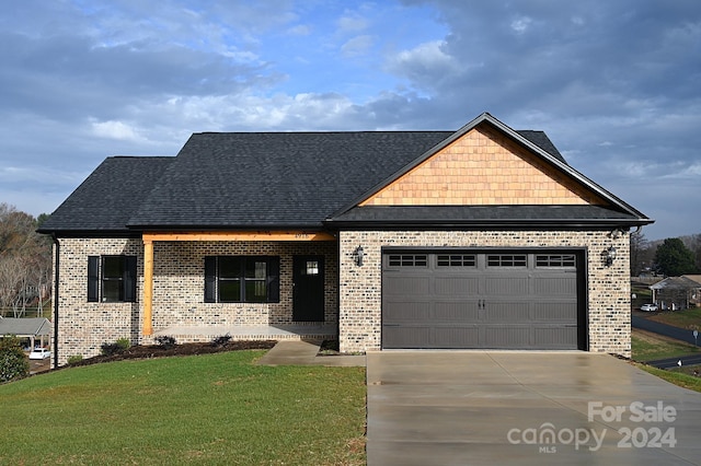 view of front facade with a garage and a front lawn