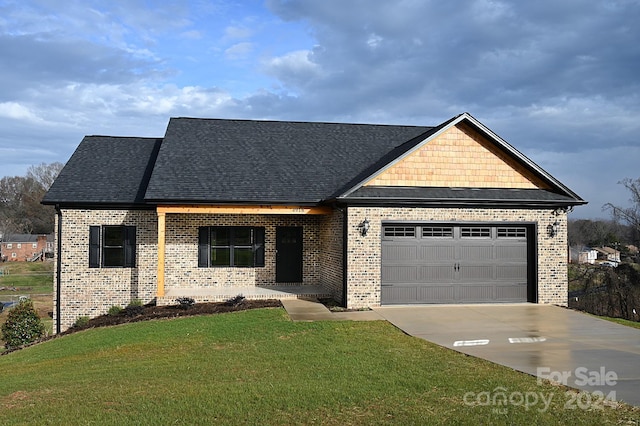 view of front of home with a front yard and a garage