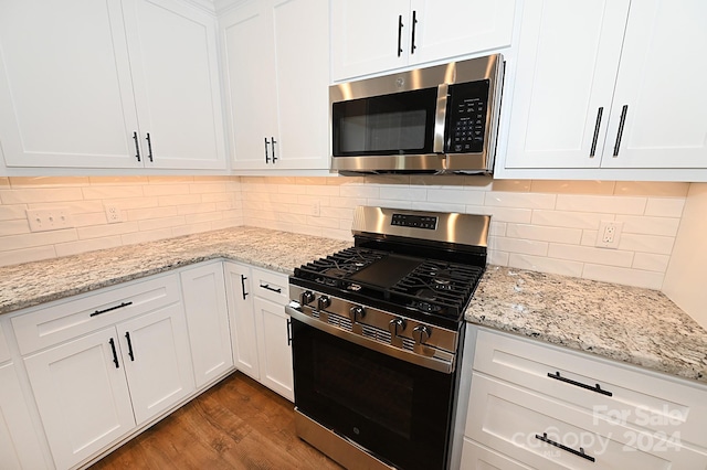 kitchen with white cabinets, light hardwood / wood-style floors, and appliances with stainless steel finishes