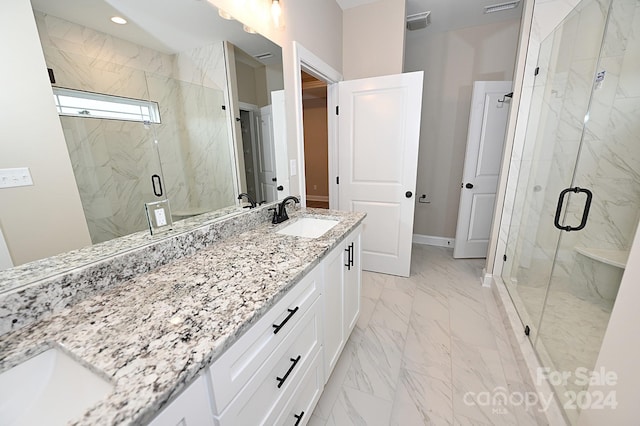 bathroom featuring vanity and an enclosed shower