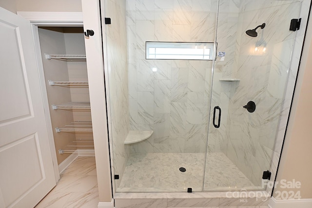 bathroom with a shower with shower door