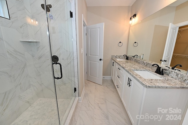 bathroom with vanity and a shower with door