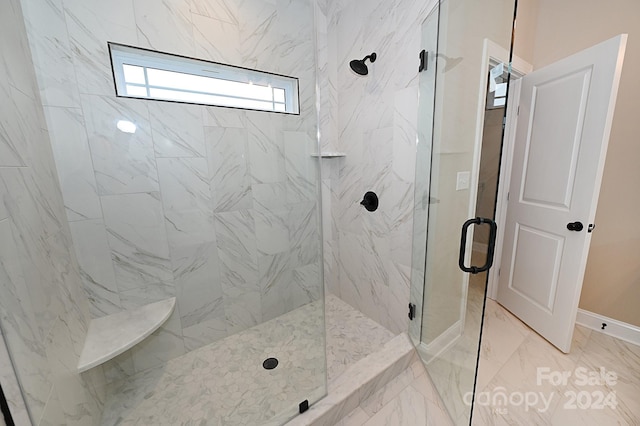 bathroom featuring a shower with shower door