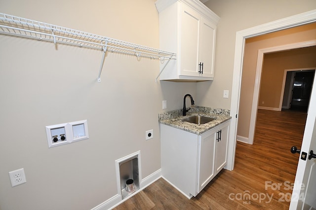 laundry room with hardwood / wood-style floors, washer hookup, cabinets, and sink