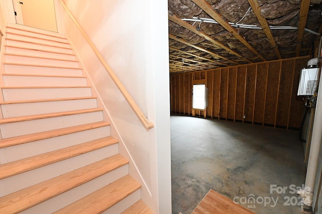 stairway featuring concrete flooring