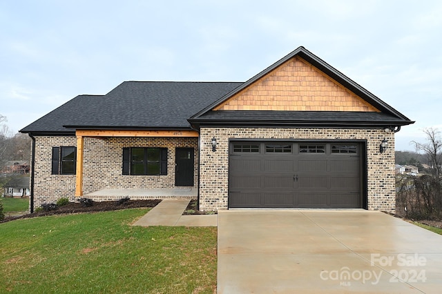 view of front of house featuring a front yard and a garage