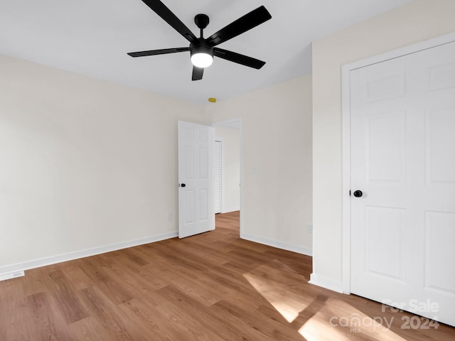 unfurnished bedroom featuring light hardwood / wood-style flooring and ceiling fan