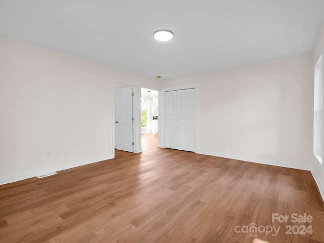 unfurnished room with light hardwood / wood-style flooring